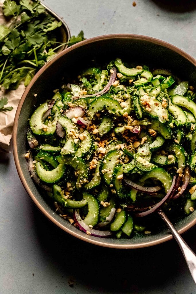 Side view of cucumber salad in serving bowl. 