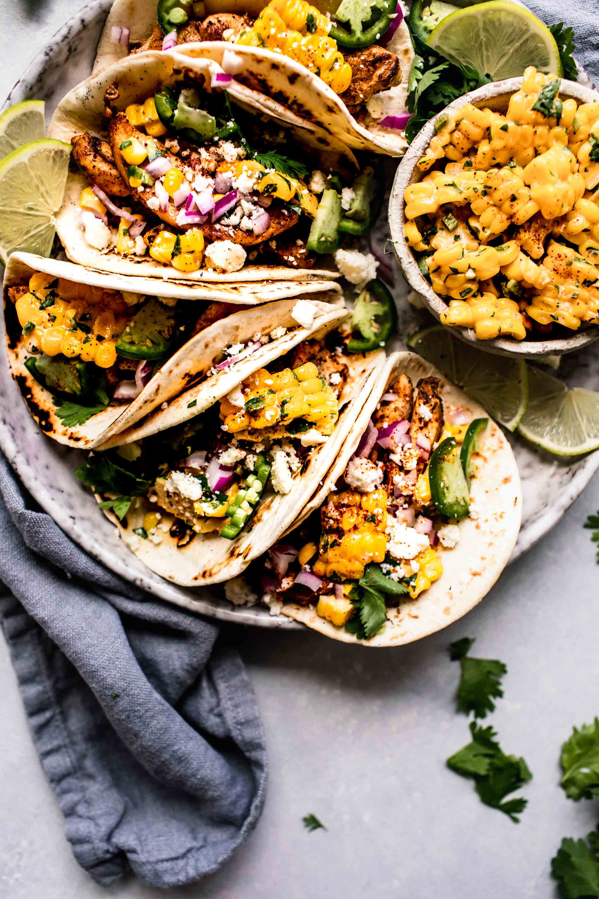 Street corn tacos arranged on plate. 