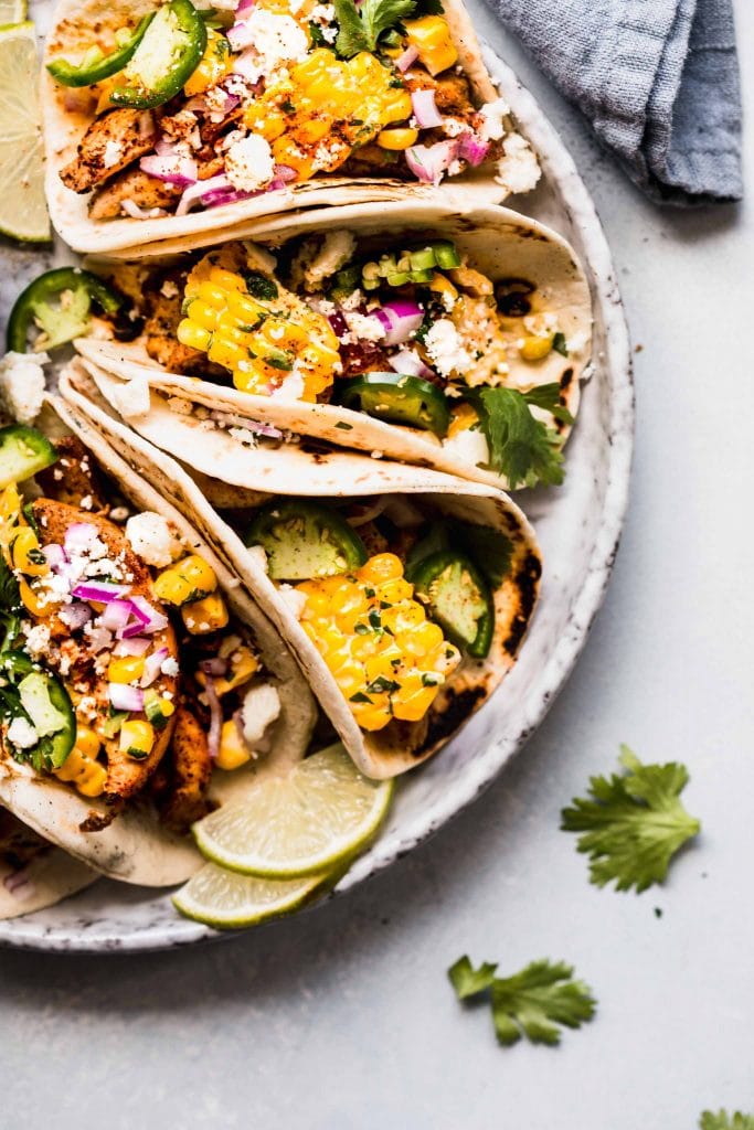 Corn tacos arranged on plate.