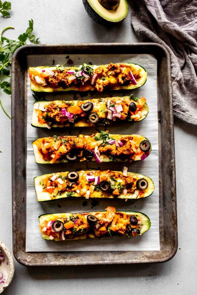 Turkey taco zucchini boats on baking sheet. 