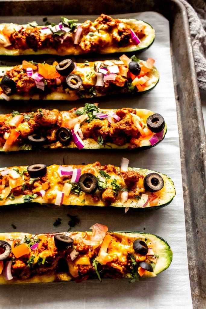 Taco zucchini boats arranged on baking sheet. 
