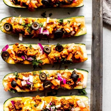 Zucchini taco boats on baking tray after cooking.