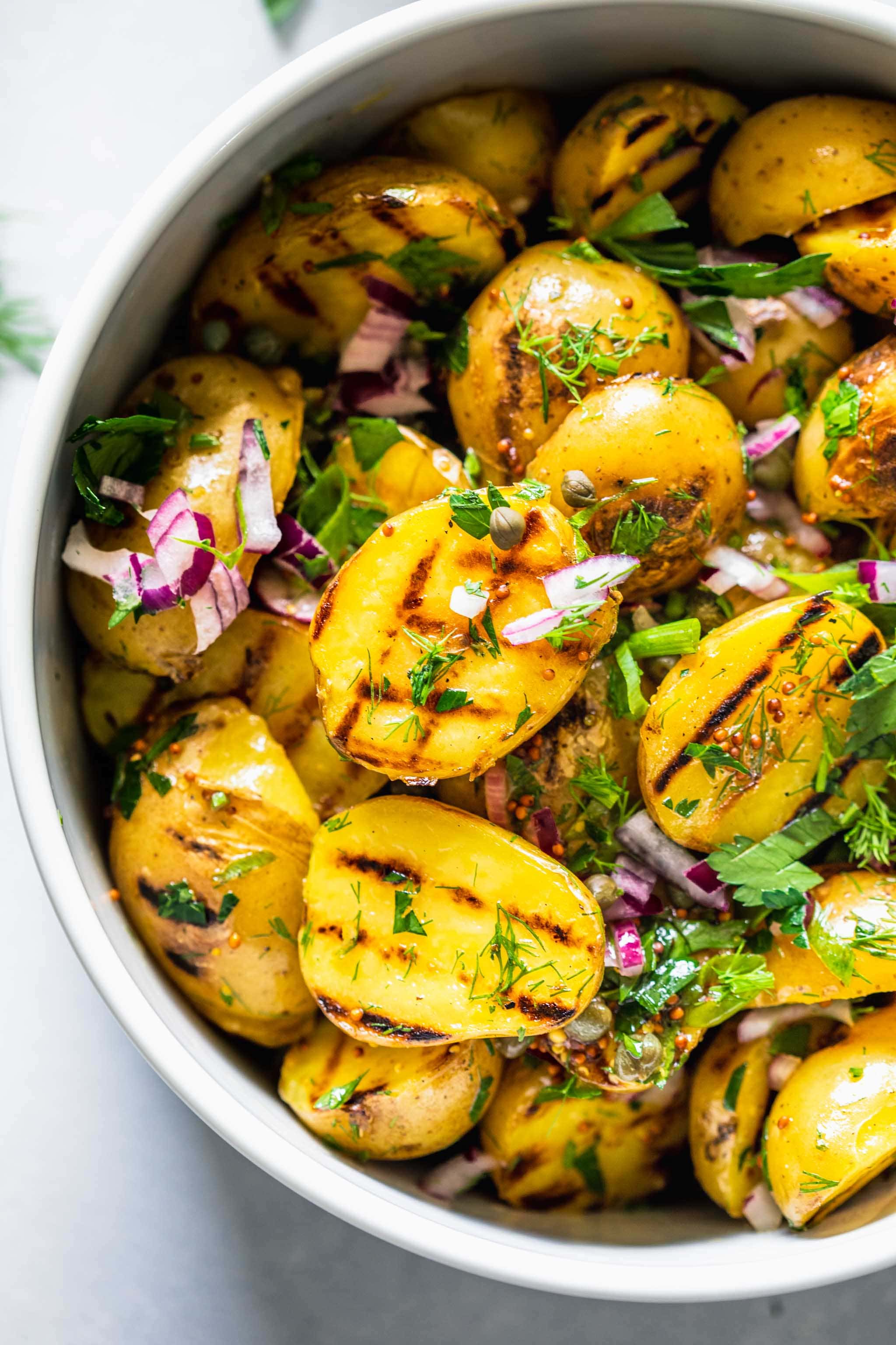 Overhead close up of bowl of grilled potato salad.