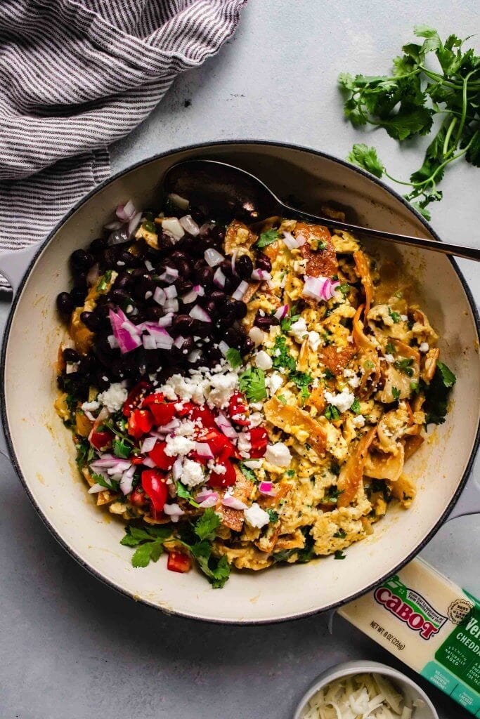 Migas in skillet with toppings. 