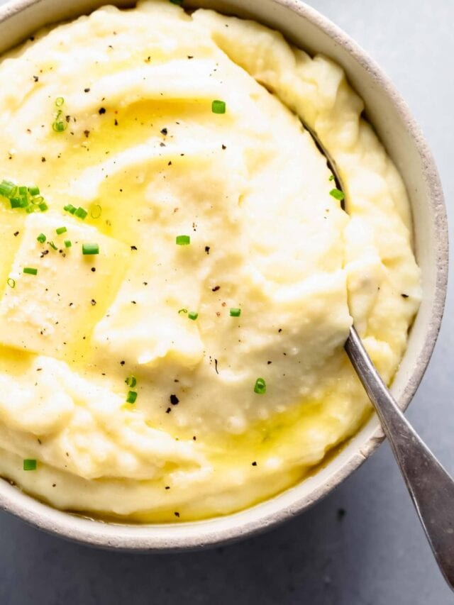Overhead shot of bowl of mashed potatoes topped with a pat of butter.