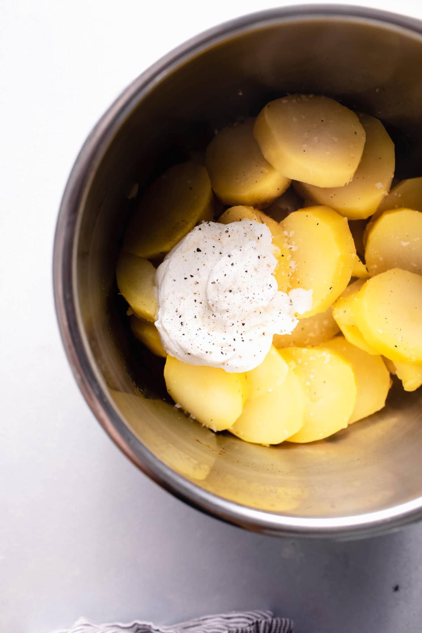 Cut cooked potatoes in instant pot with dollop of sour cream.