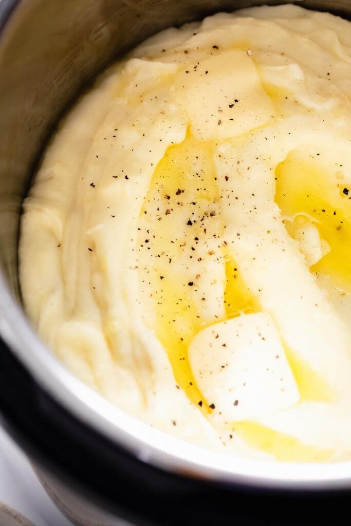 Mashed potatoes in instant pot topped with butter.