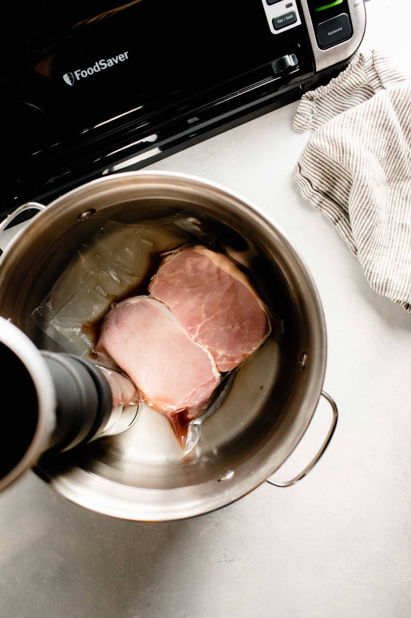 Pork chops in sous vide water bath.