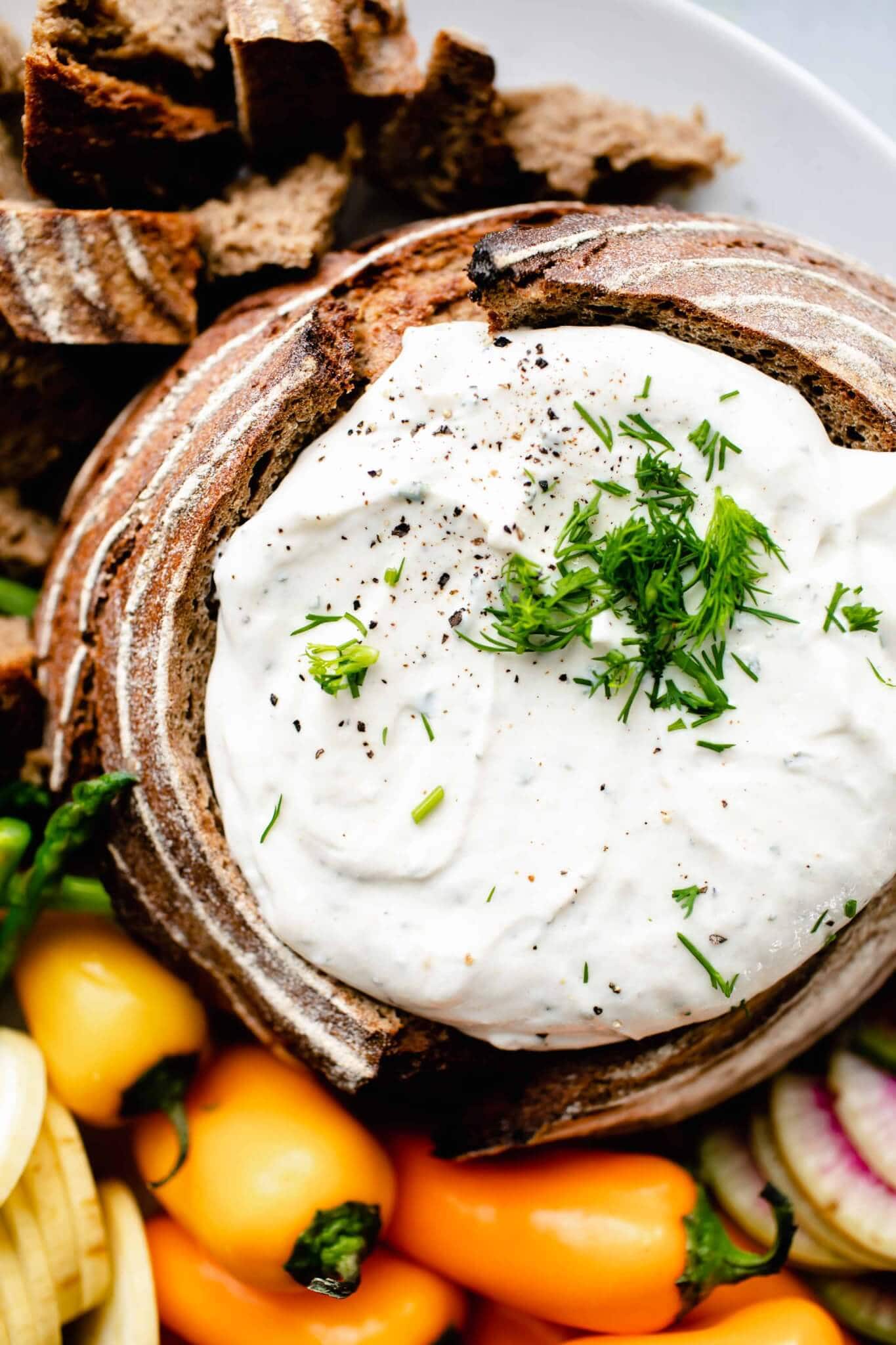 Overhead close up of greek yogurt ranch dip in bread bowl.