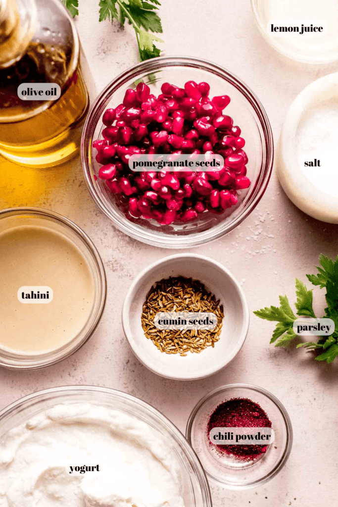 Ingredients for tahini yogurt sauce labeled on counter. 
