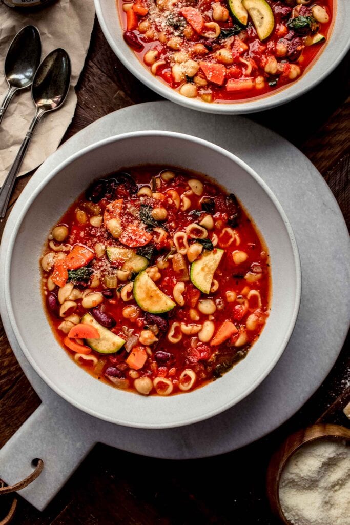 Two bowls of minestrone soup. 