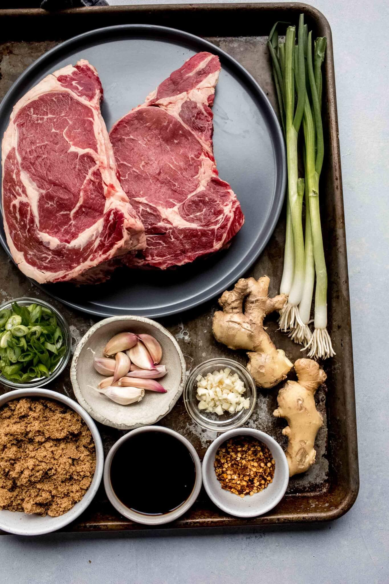 Ingredients for mongolian beef laid out on baking sheet.