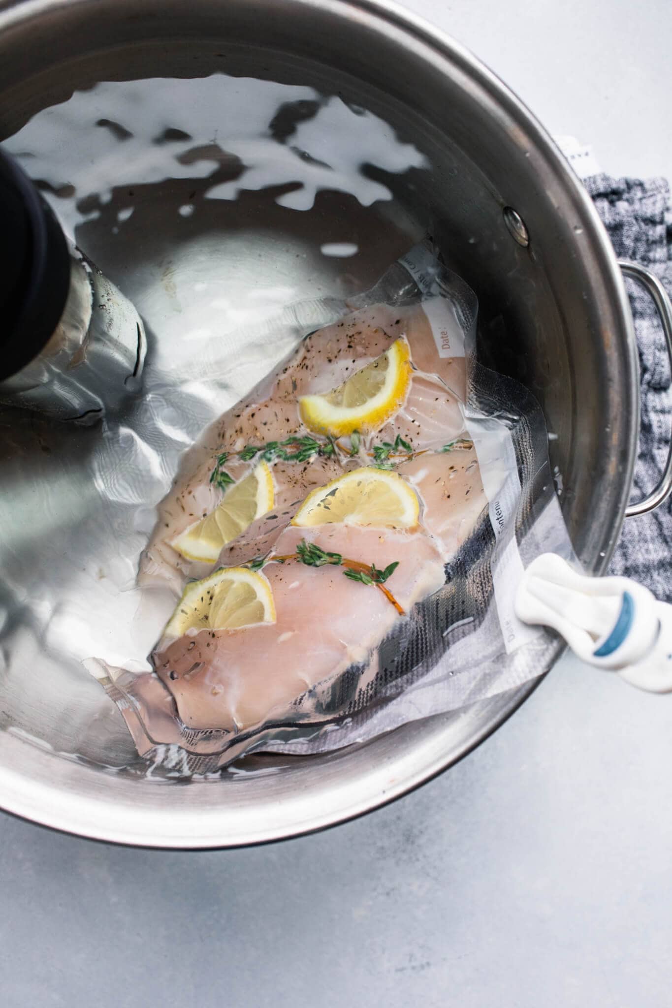 Bag of chicken breasts in sous vide water bath.