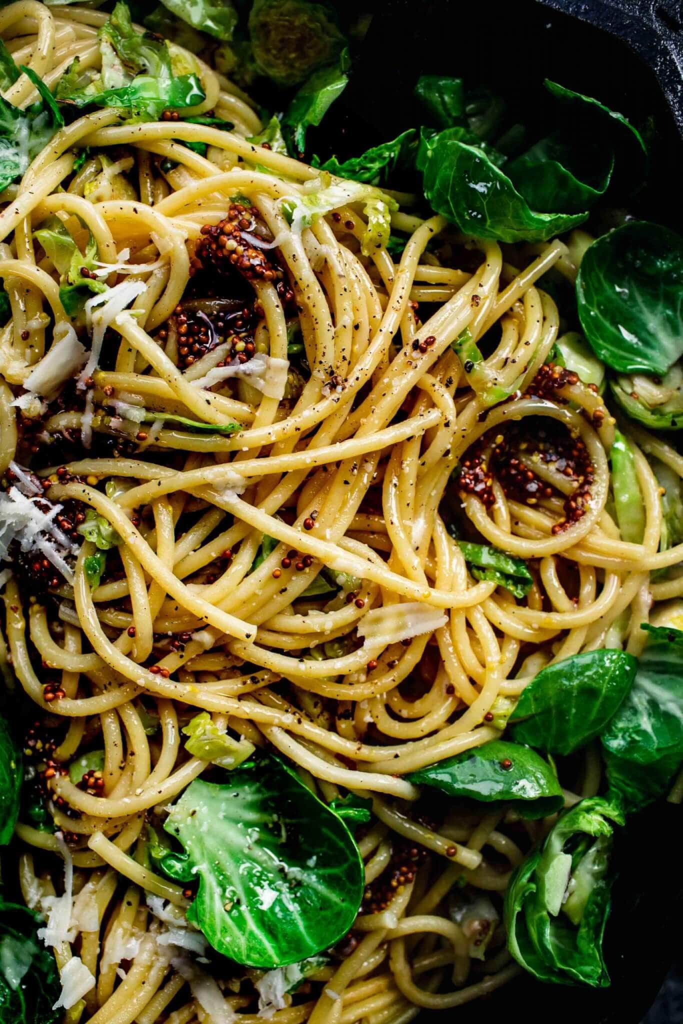 Close up of brussel sprout pasta with grainy mustard.