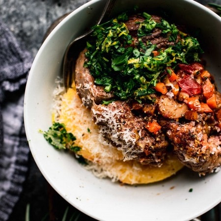 Overhead close up of bowl with polenta and osso buco.