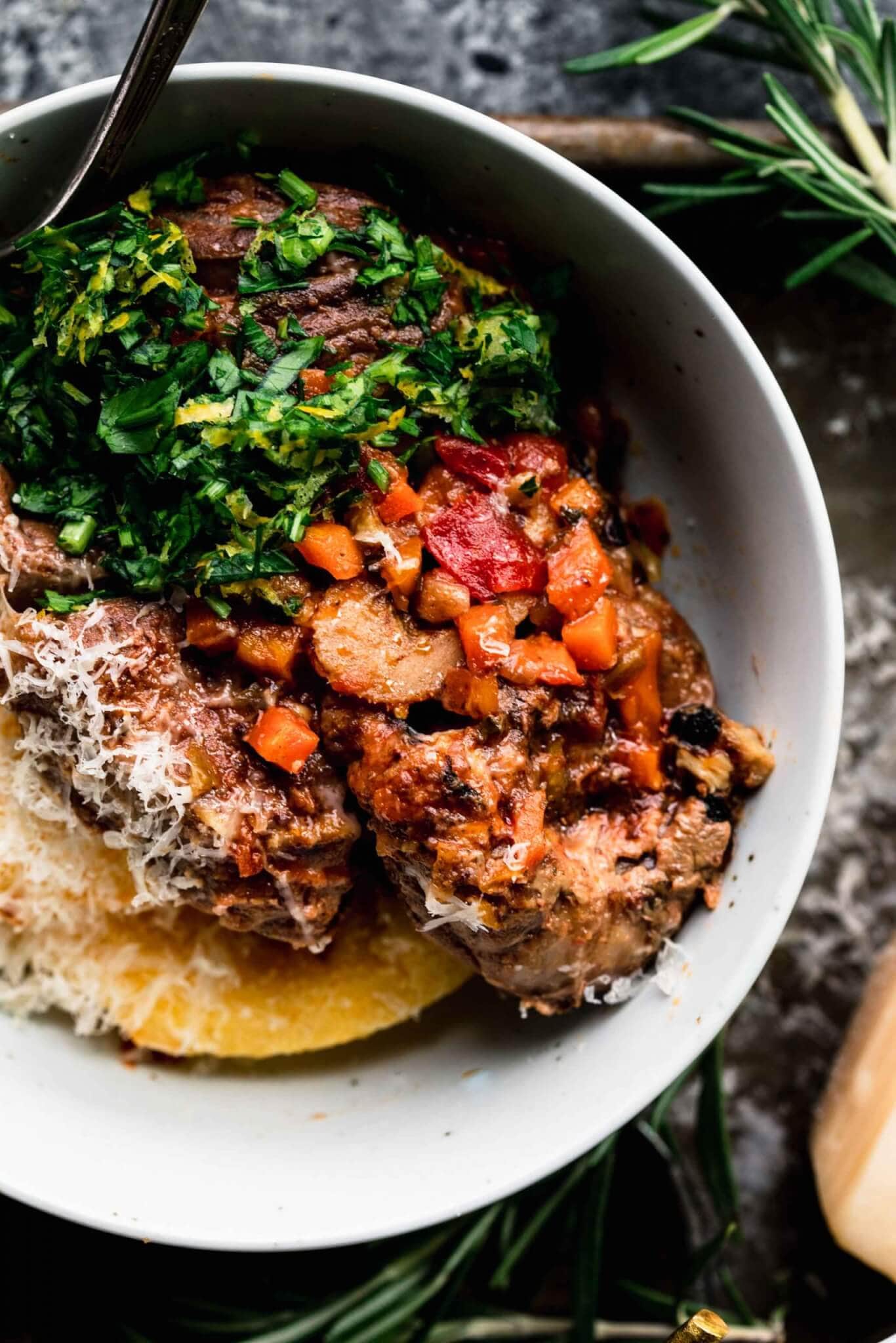 Overhead close up of bowl with polenta and osso buco.