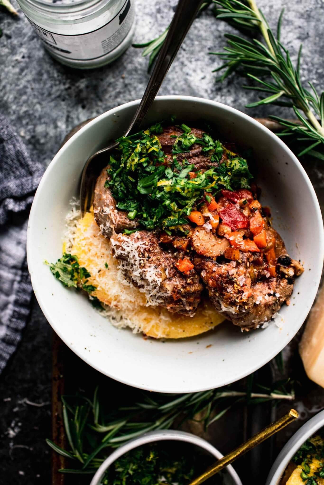 Overhead close up of bowl with polenta and osso buco.