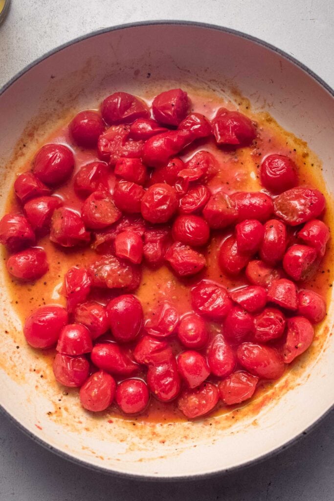 Burst tomatoes in skillet.