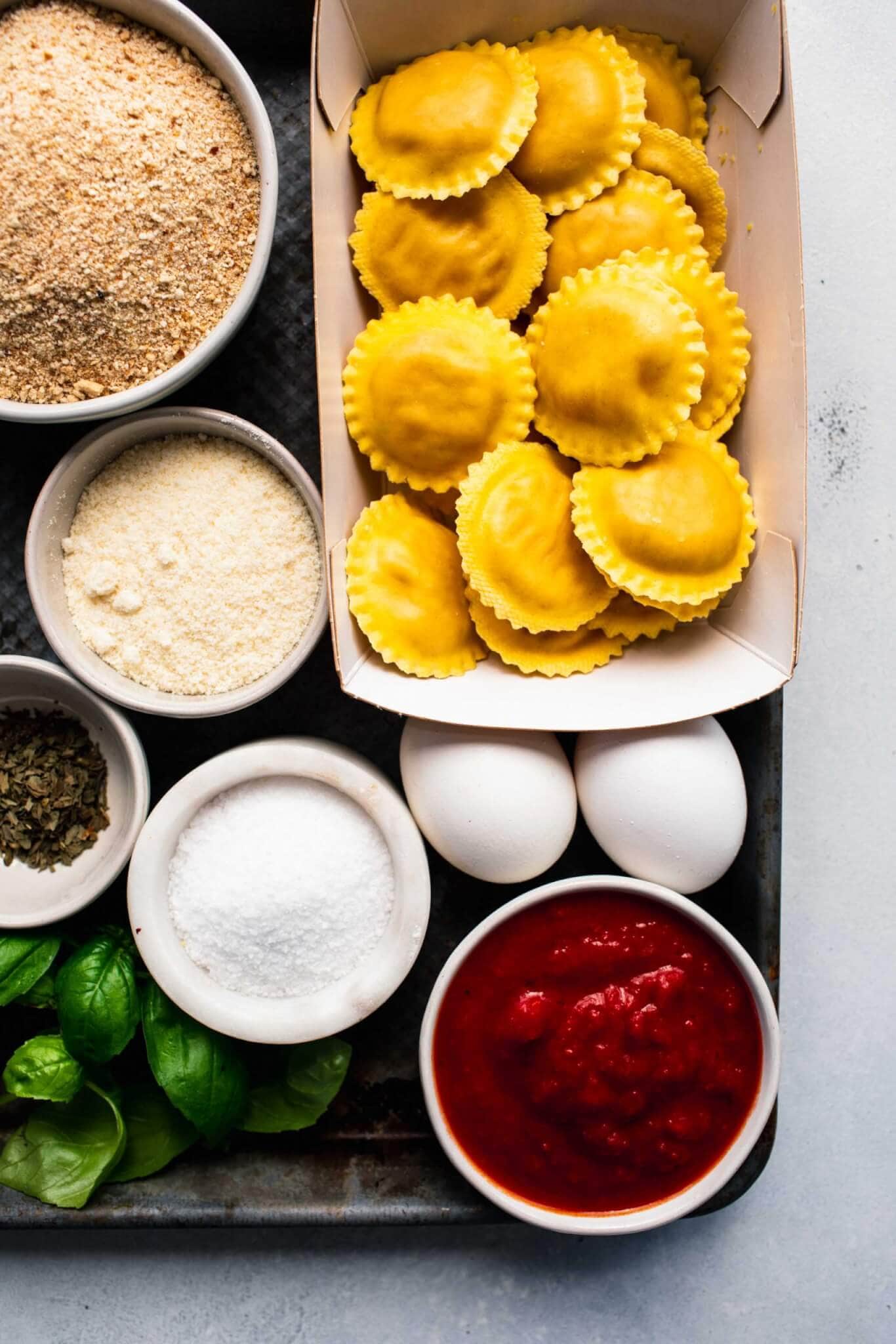 Ingredients for toasted ravioli laid out on baking tray.