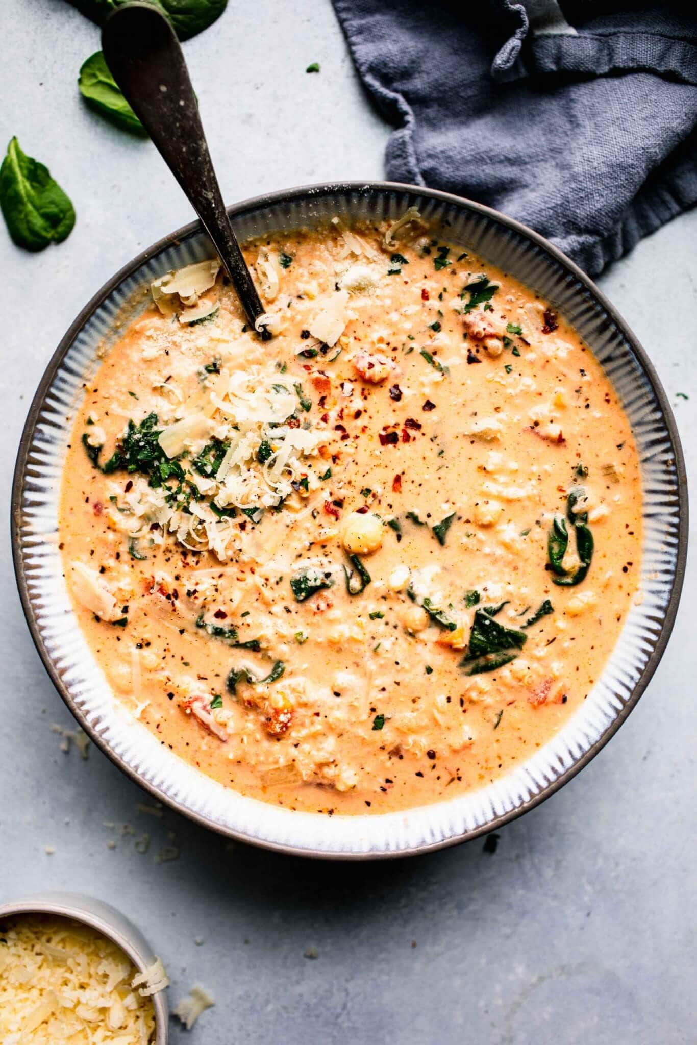 Bowl of creamy quinoa soup with spoon. 