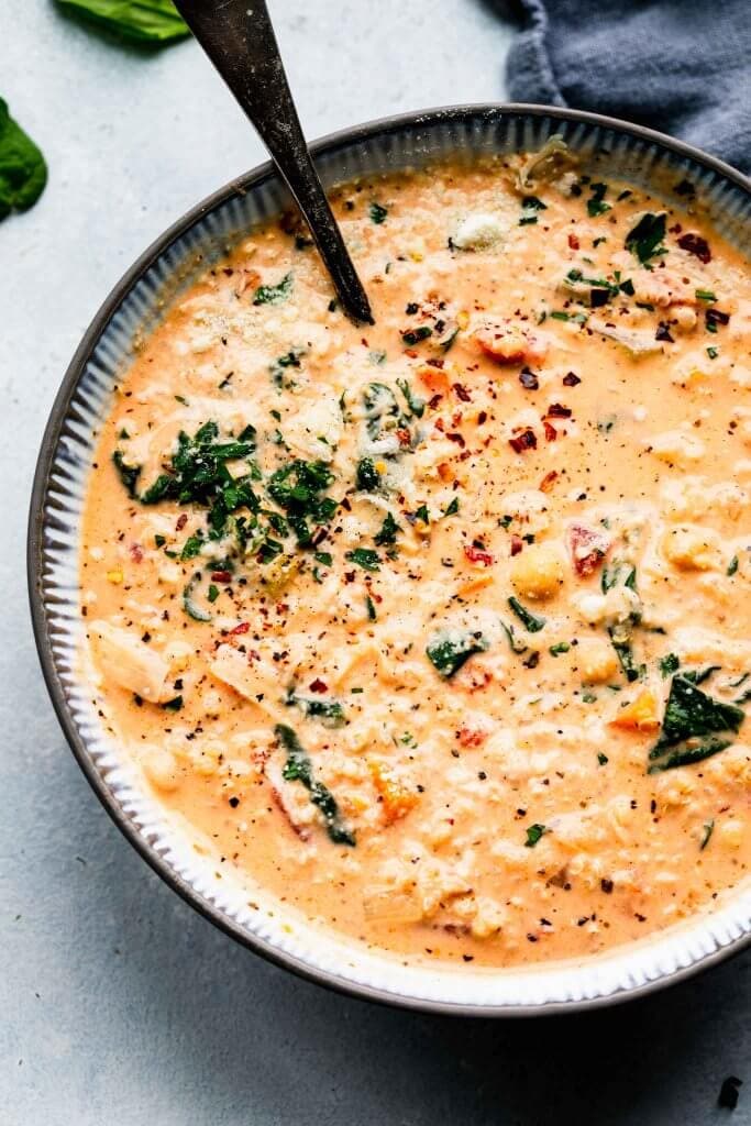 Bowl of creamy quinoa soup with spoon.