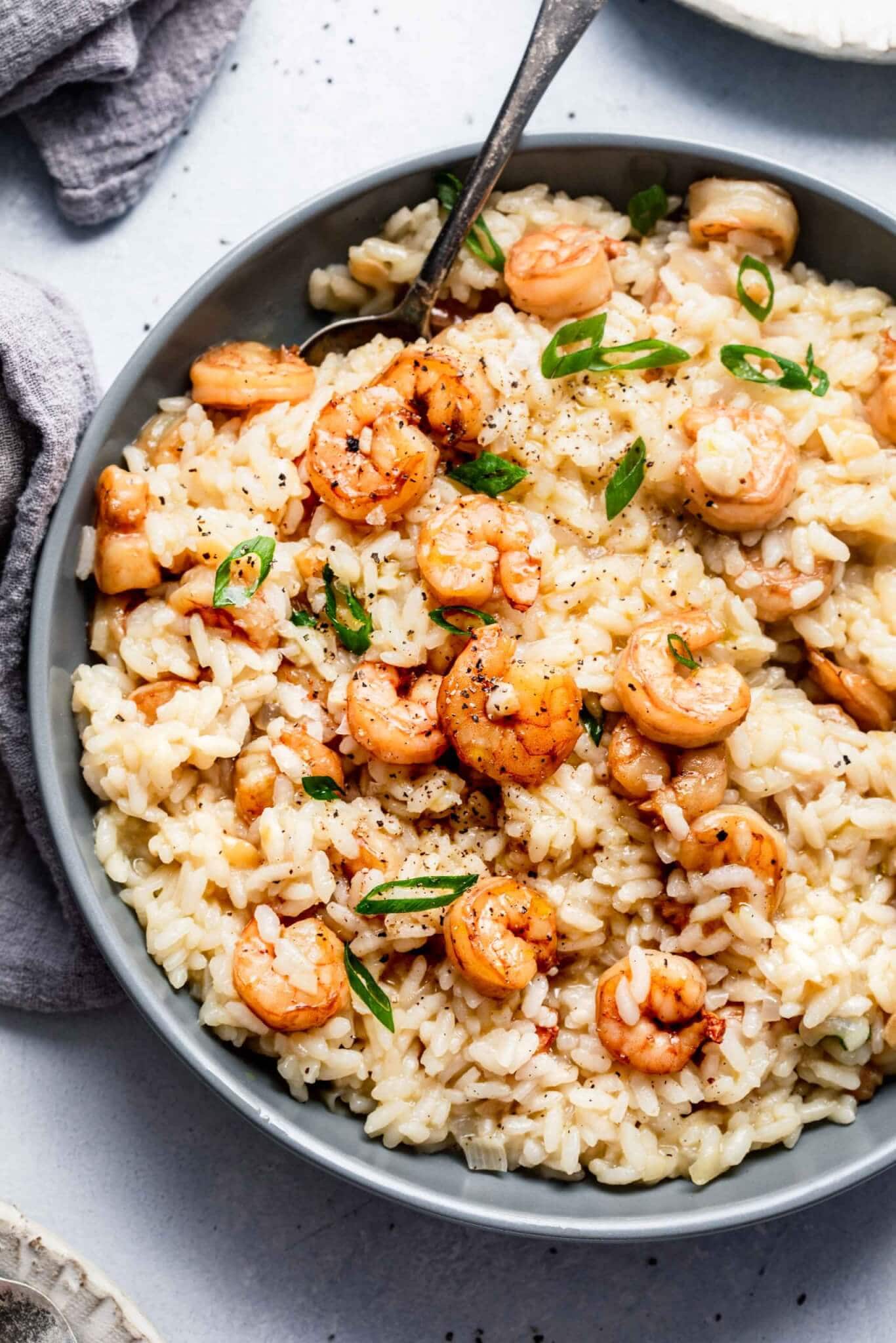 Overhead shot of bowl of shrimp risotto in grey serving dish.