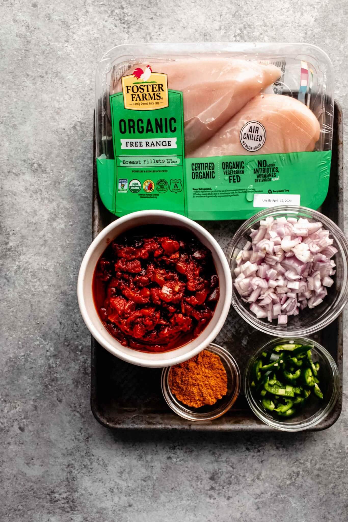 Ingredients for slow cooker salsa chicken laid out on tray. 