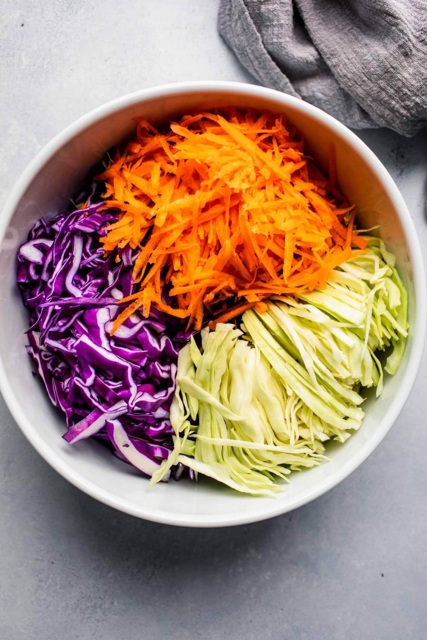 Shredded cabbage and carrots in large mixing bowl.