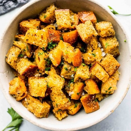 Bowl of croutons sprinkled with parsley.