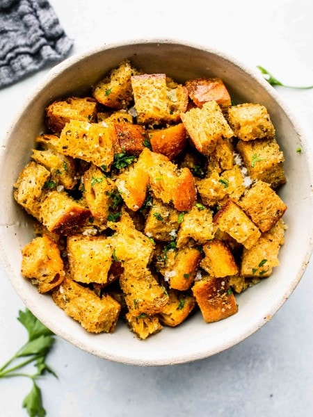 Bowl of croutons sprinkled with parsley.