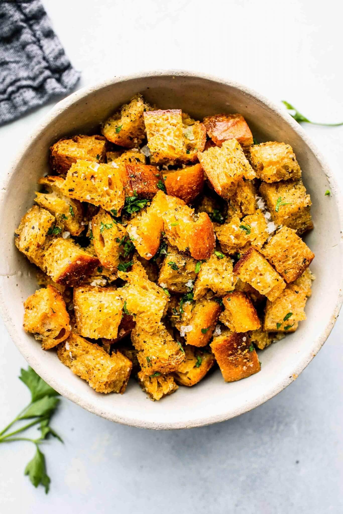 Bowl of croutons sprinkled with parsley.