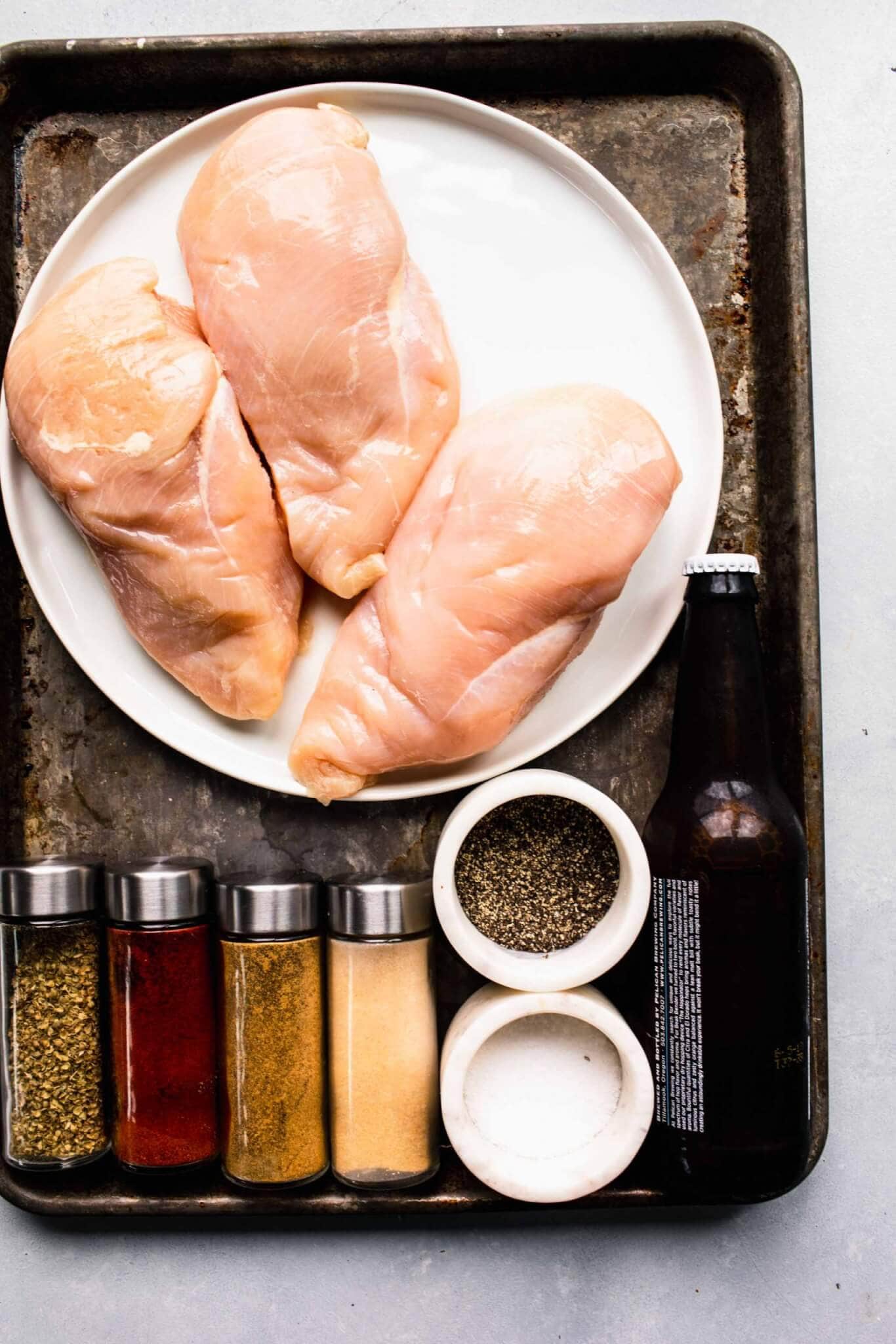 Ingredients for instant pot chicken breasts laid out on tray.