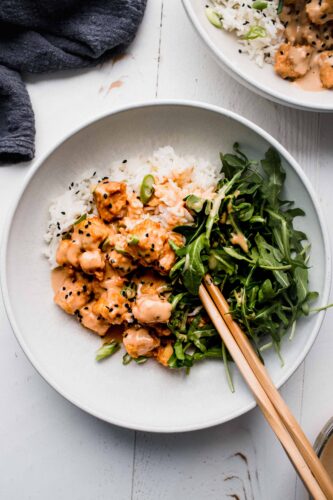 Overhead shot of peanut tofu on bowl of rice.