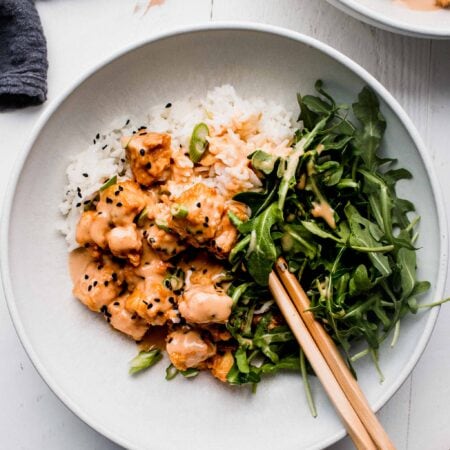 Overhead shot of peanut tofu on bowl of rice.