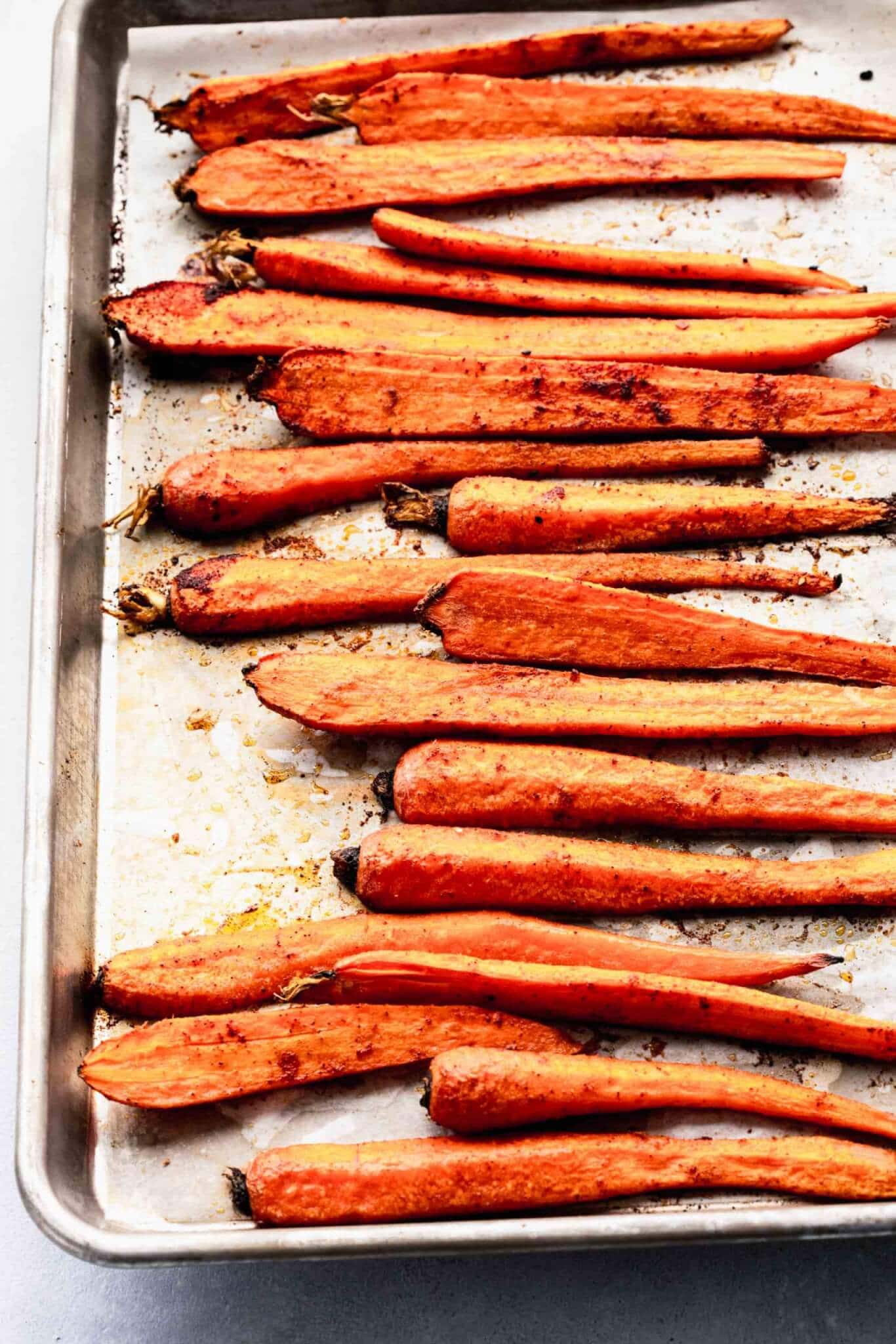 Oven roasted carrots on baking sheet.