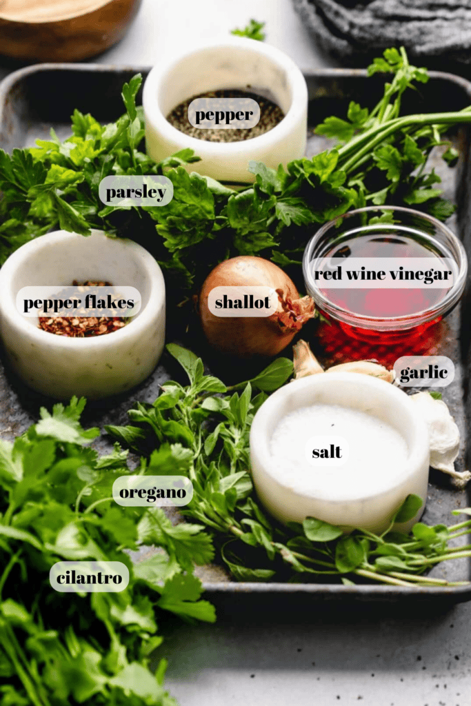 Ingredients for chimichurri labeled on counter. 