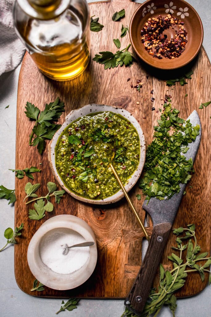 Ingredients for chimichurri on chopping board. 