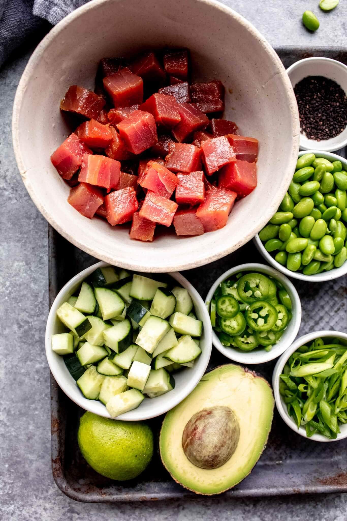 Ingredients for poke bowls laid out on tray