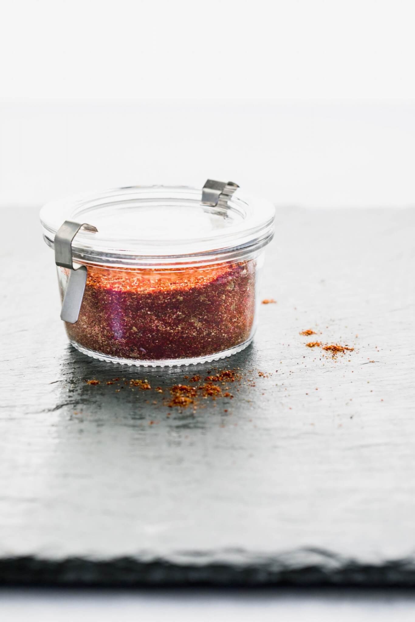 SIDE VIEW OF COMBINED TACO SEASONING IN GLASS CONTAINER WITH LID