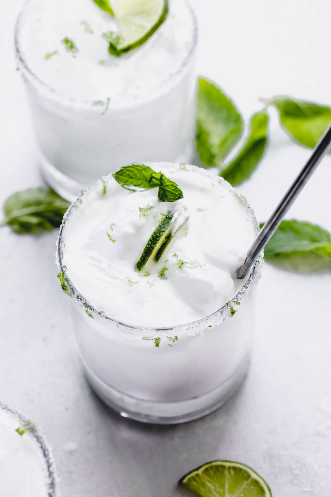 Side view of two coconut mojitos. 