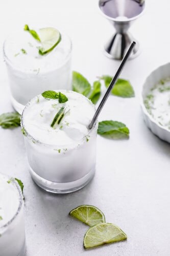 Side view of two coconut mojitos.