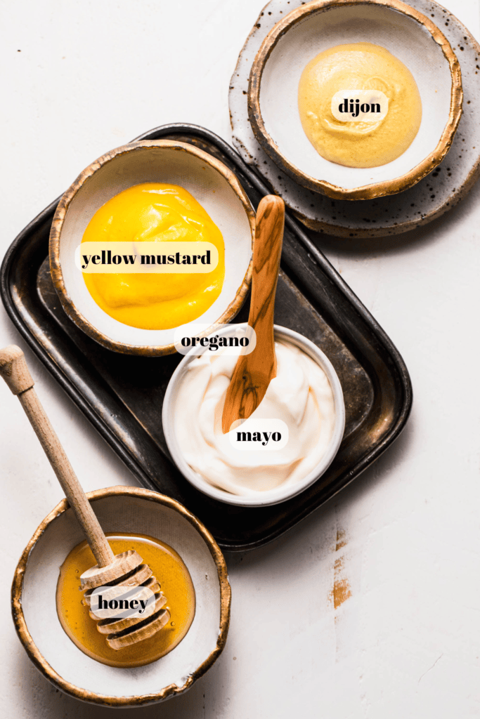 Ingredients for honey mustard dipping sauce labeled on counter. 