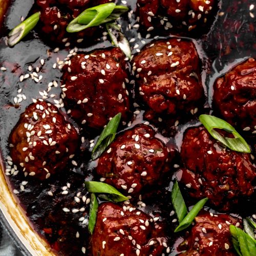 Close up of meatballs in skillet with mongolian sauce.