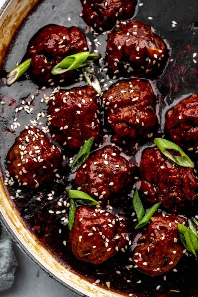 Close up of meatballs in skillet with mongolian sauce.