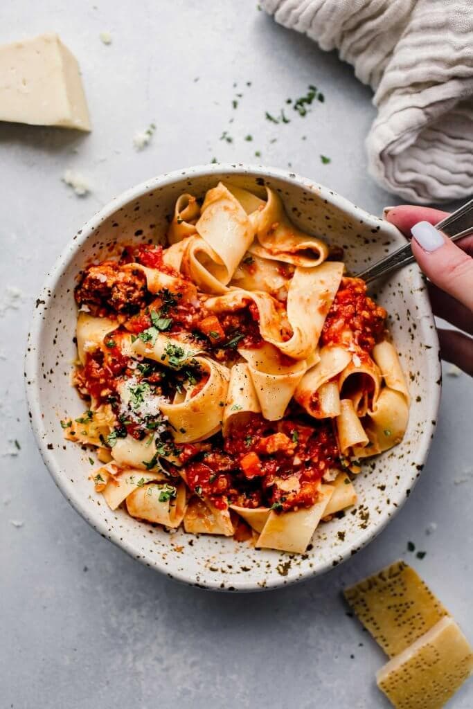 Overhead close up of bowl of pasta topped with slow cooker bolognese