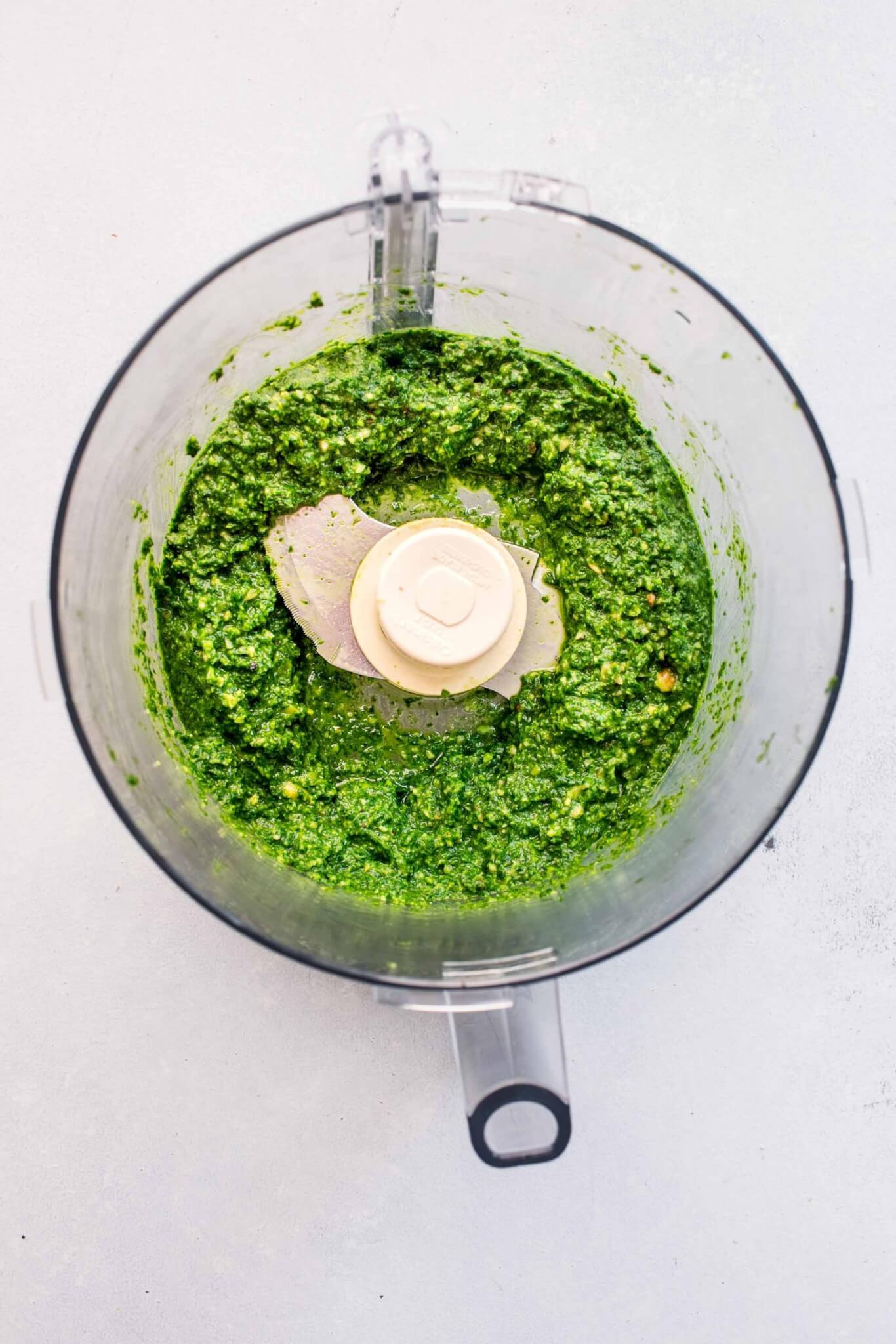 Kale pesto in food processor after processing.