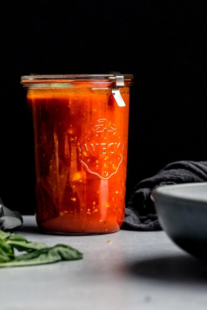 Side view of marinara sauce in jar. 