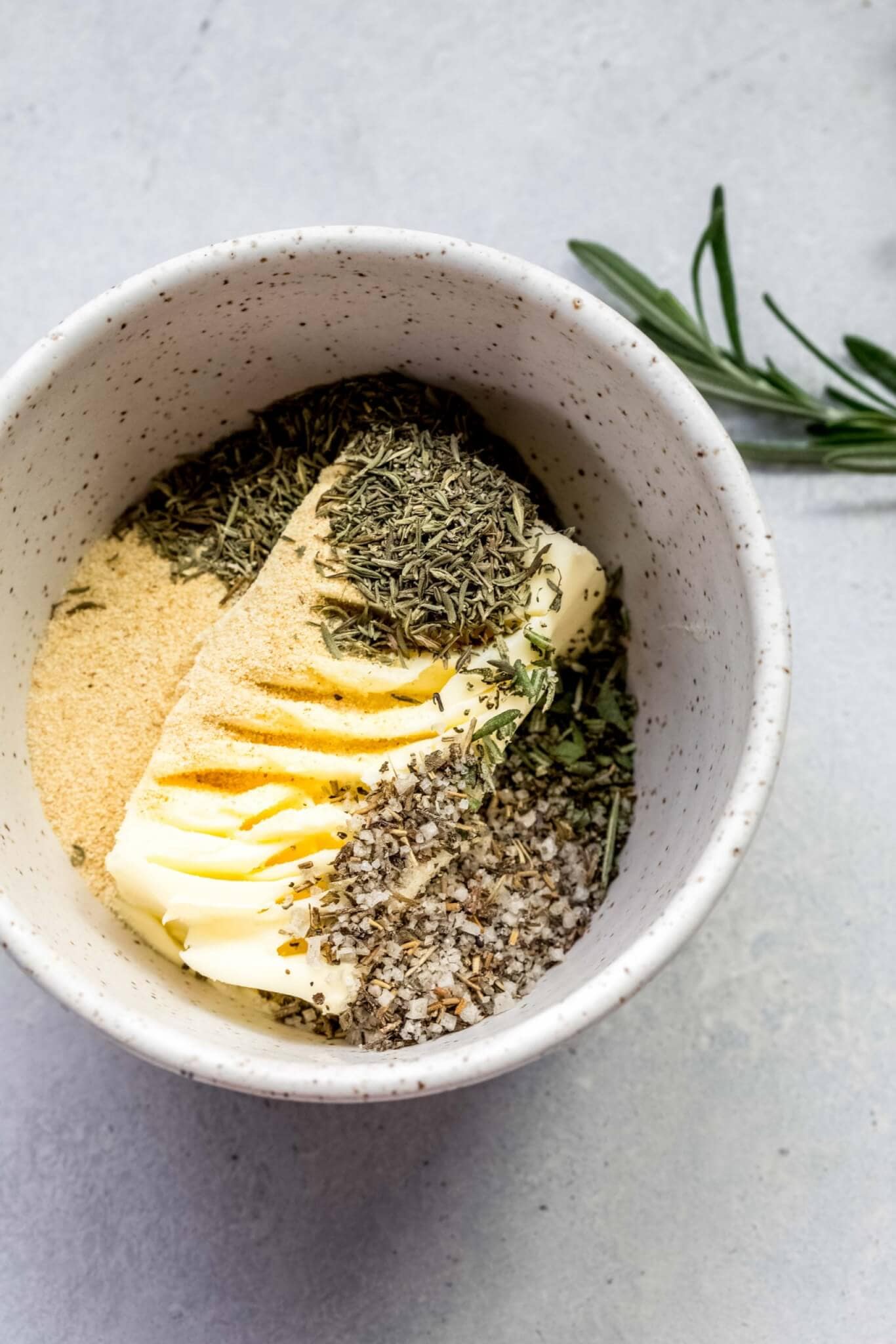 Butter being mixed with herbs.