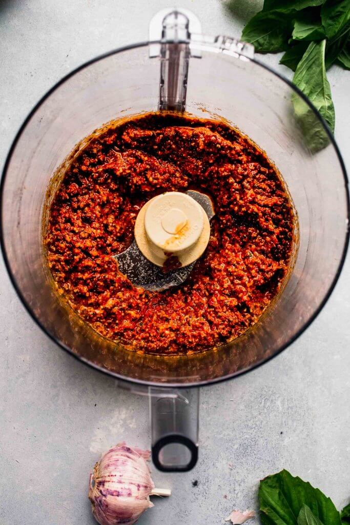Pesto rosso processed in food processor bowl. 