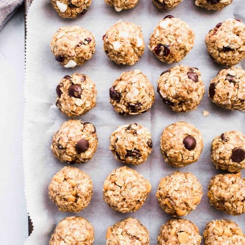 Energy bites arranged on baking sheet.